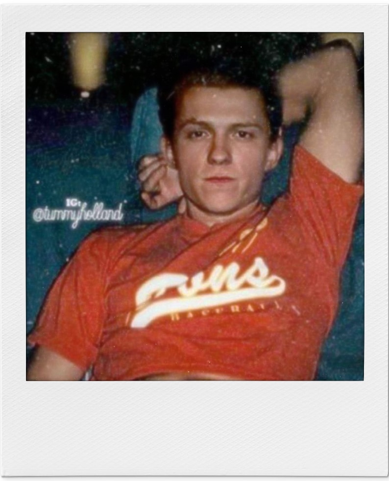 relaxed looking young man in red t-shirt with arm behing head.